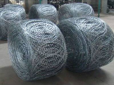 Many rolls of razor wire flat wrap coils