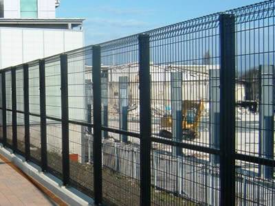 A black roll top fence with a intermediate rail and unique roll top and bottom structure is high and safe, and it is installed between the road and construction site.