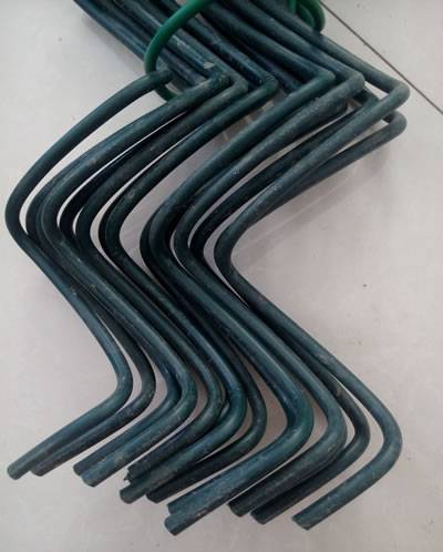A bundle of dark green PVC coated chain link wire.