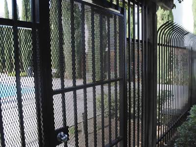 A black PVC coated expanded metal fence is used for house fencing and gate.