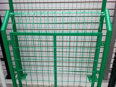 A green PVC coated welded fence with rectangular frame and round post.