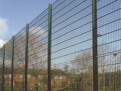 A dark green PVC coated prison security fencing is installed in the playground.