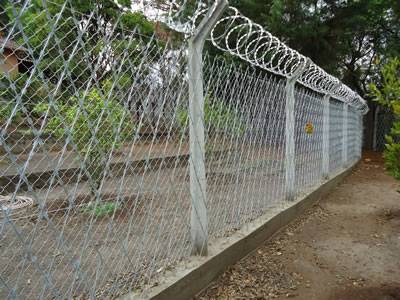 Welded and concertina razor wire combined with chain link fence for high level security fencing.