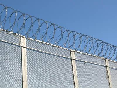 Combined with razor wire, expanded metal fence with small mesh size achieves high level security.