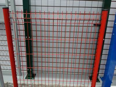 A red PVC coated welded fence with peach post and a dark green PVC coated welded fence with rectangular post.