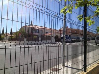 AA black PVC coated welded wire 3D security fence is installed beside the road to protect passengers.
