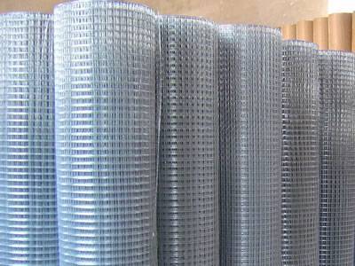 Many rolls of galvanized welded mesh are placed in workshop.
