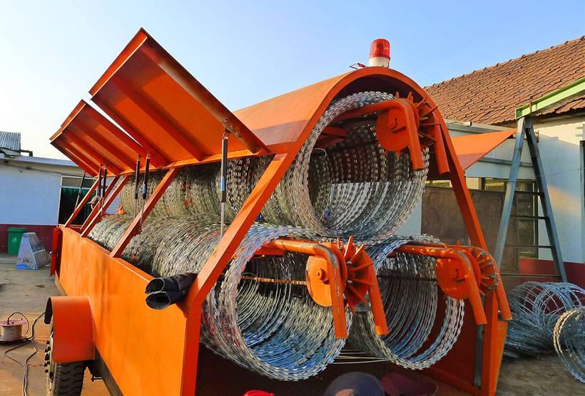 In orange color trailer, there are 3 coils of razor wire with stretching system.